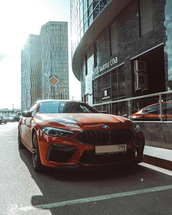 the car is driving down the road near the buildings