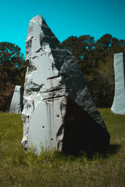 some very big stones sitting in the grass