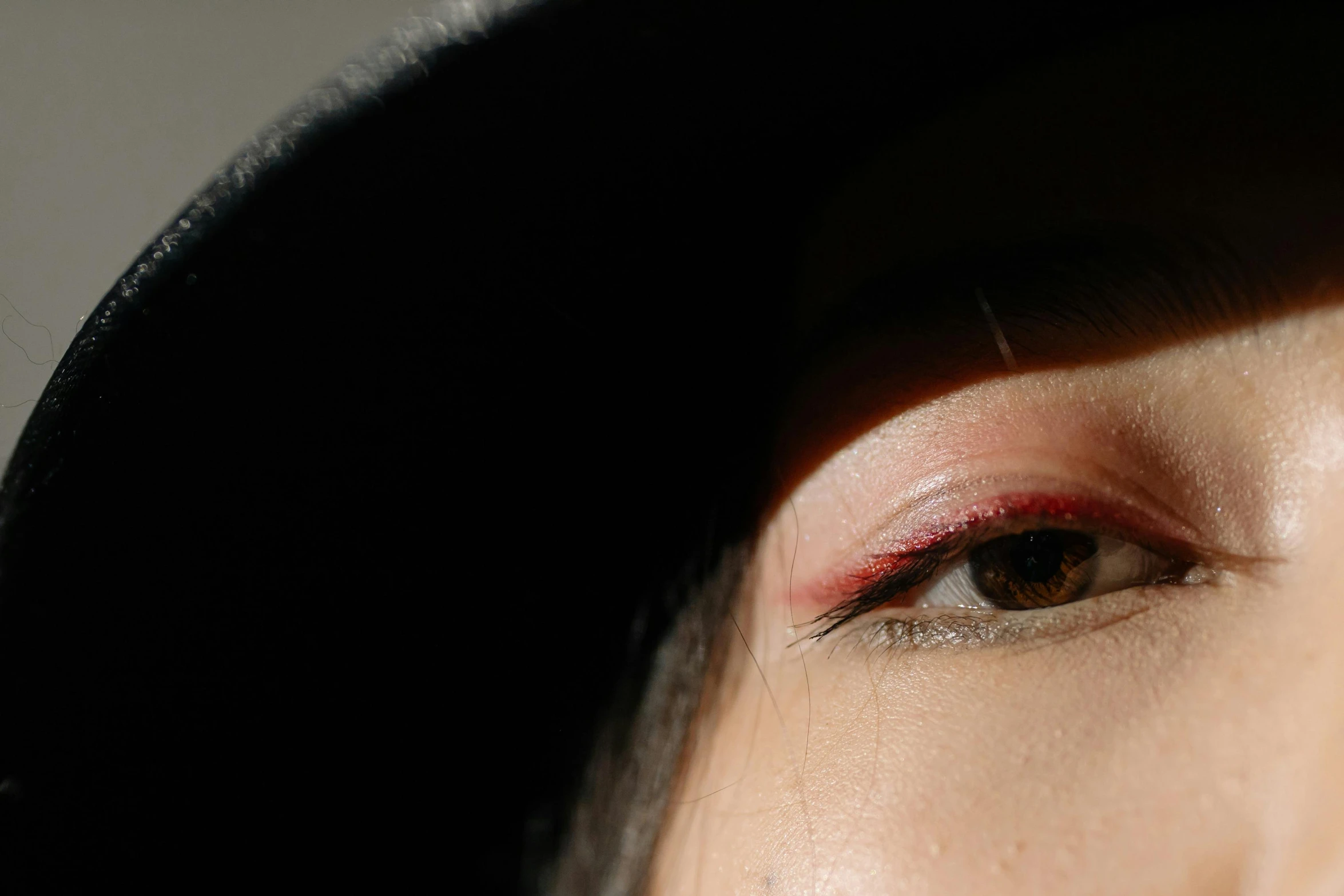 a woman with a red eyeliner and red liner