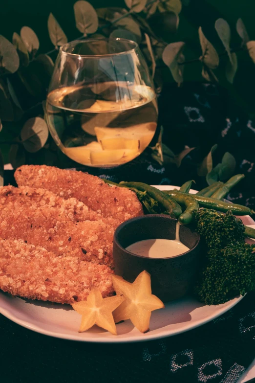 a white plate topped with fried fish and vegetables