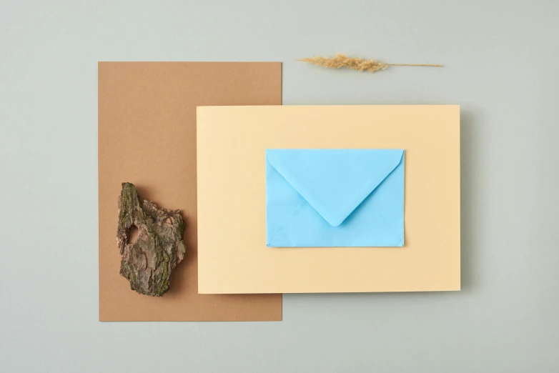 paper and a piece of cardboard on top of a table