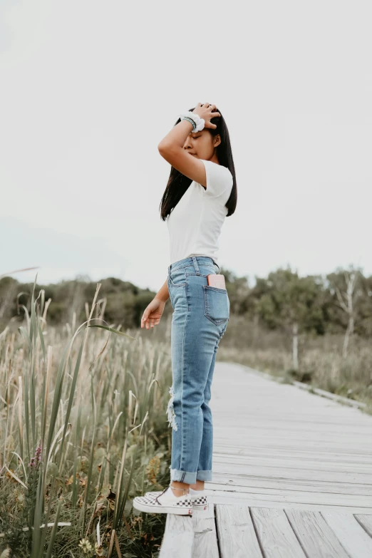 a woman is drinking soing on the pier