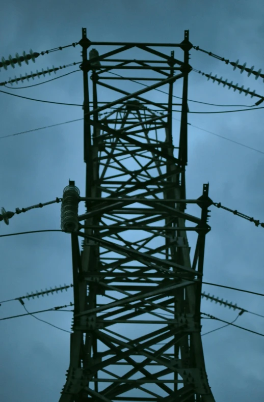 an image of a tower with electric wires