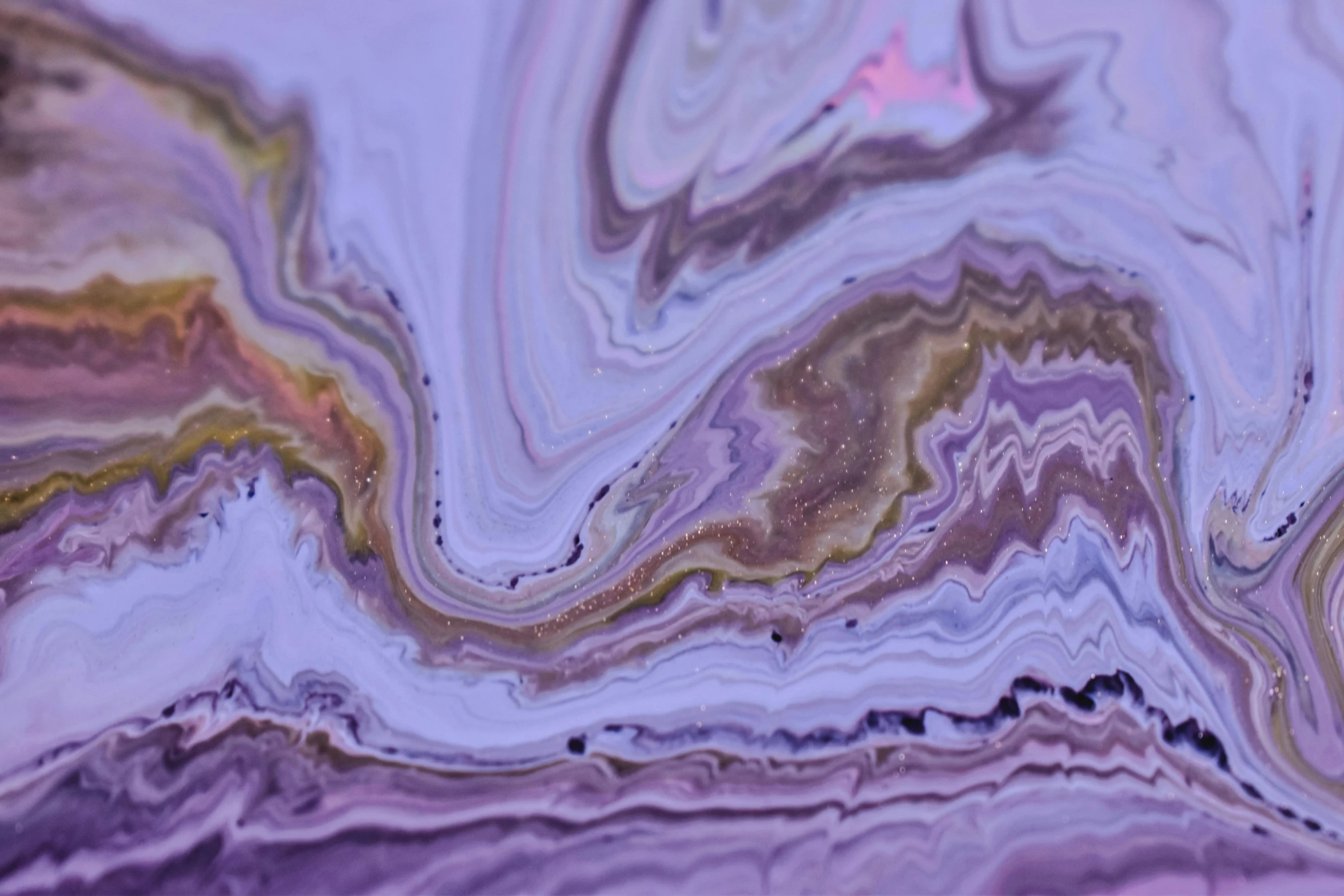 some fluid, purple, and gold designs on a surface