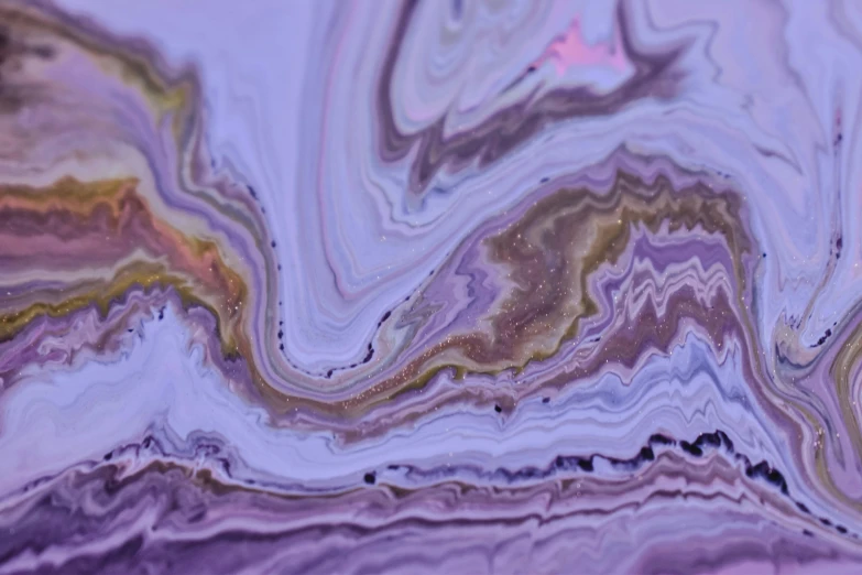 some fluid, purple, and gold designs on a surface