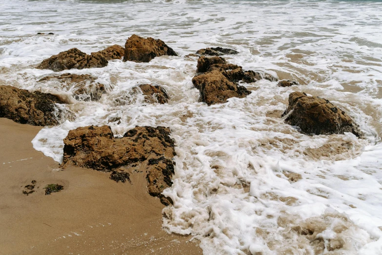 some very pretty rocks on the shore by the water