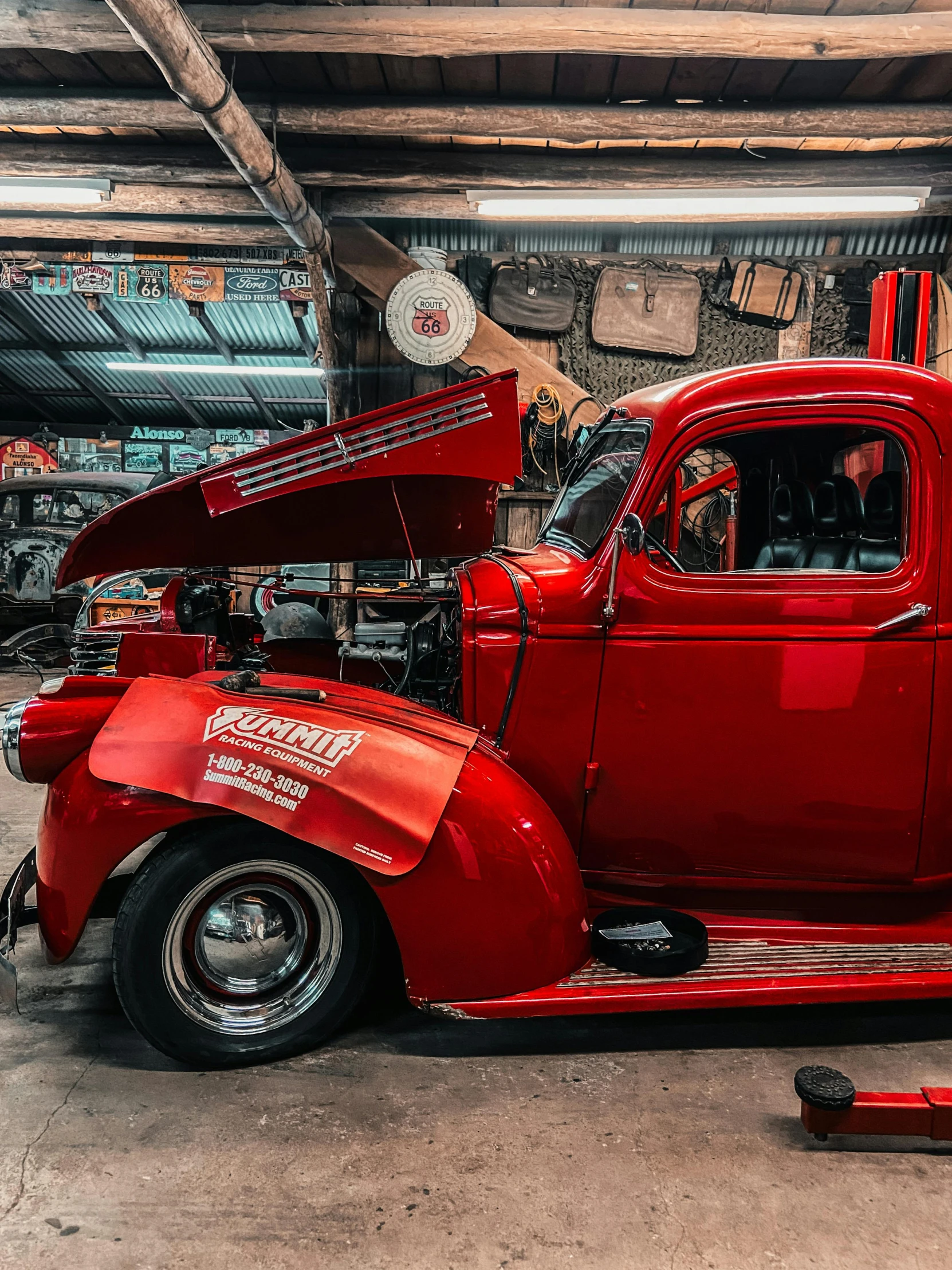 an older red pickup truck with its hood up