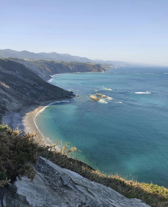 an aerial view looking down on the water and sand