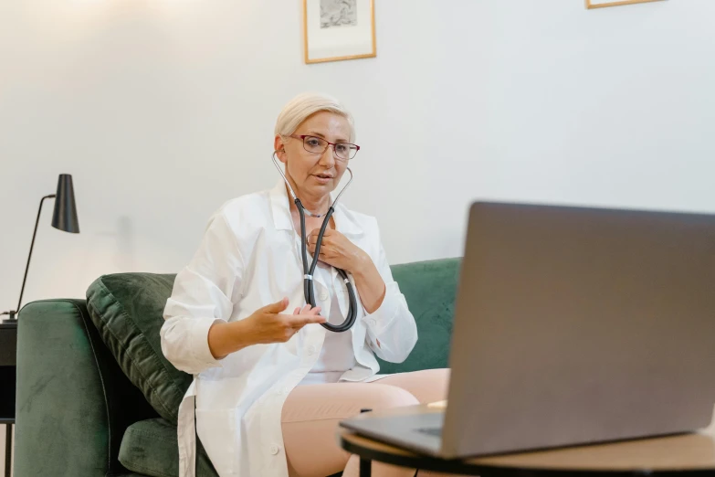 a woman is using a stethoscope to examine her stomach