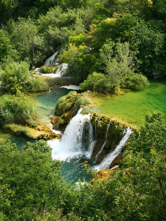 an aerial s of waterfalls on a mountain side