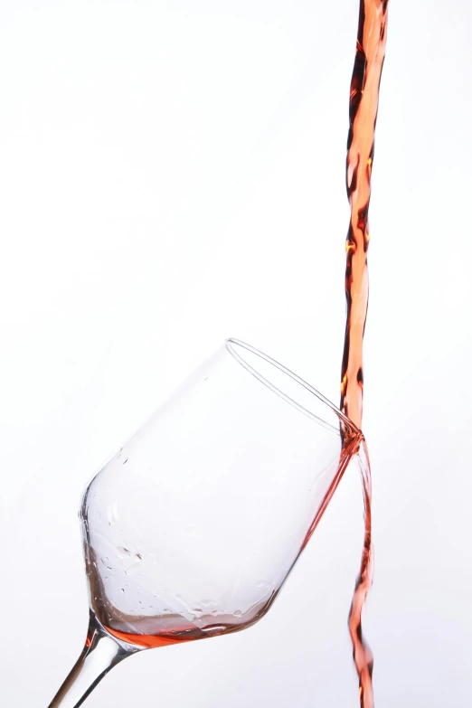 a wine glass being filled with a liquid