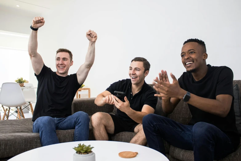 three men having a good time playing a video game together