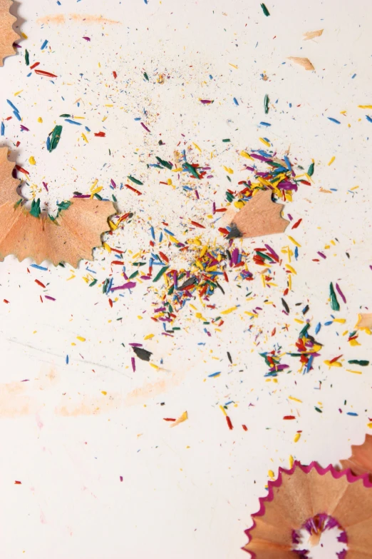 a table with umbrellas and confetti in the middle