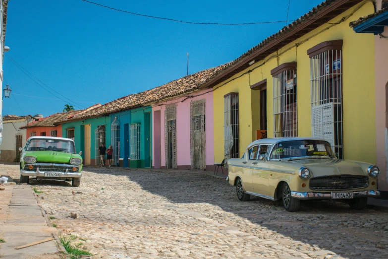 cars parked on the side of a colorful road