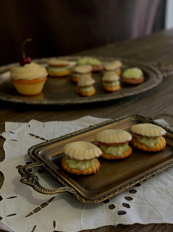 an arrangement of various desserts on a platter and in glass plates