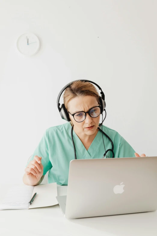 a woman with headphones on has a laptop