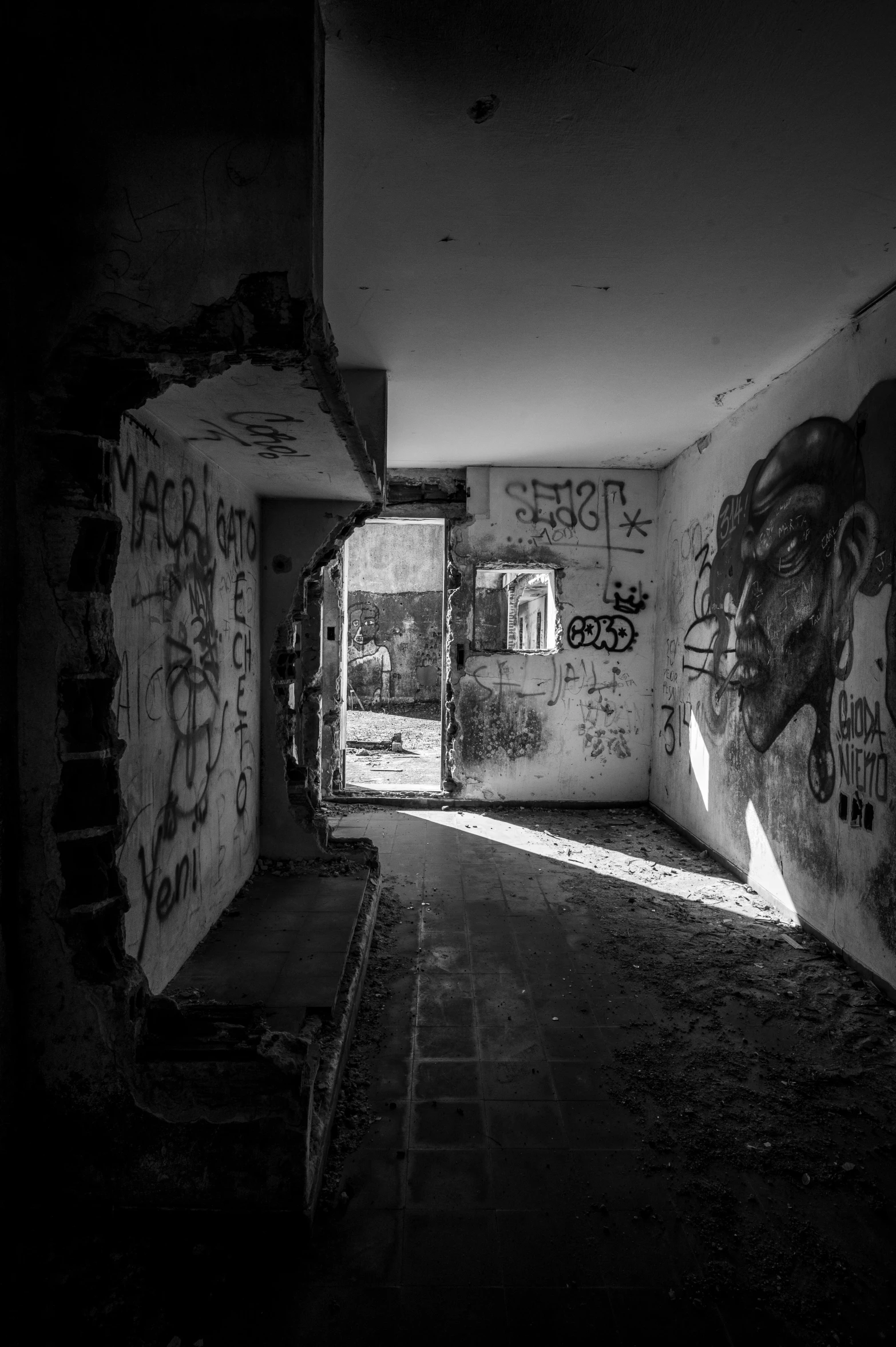 the dark hallway with graffiti is empty