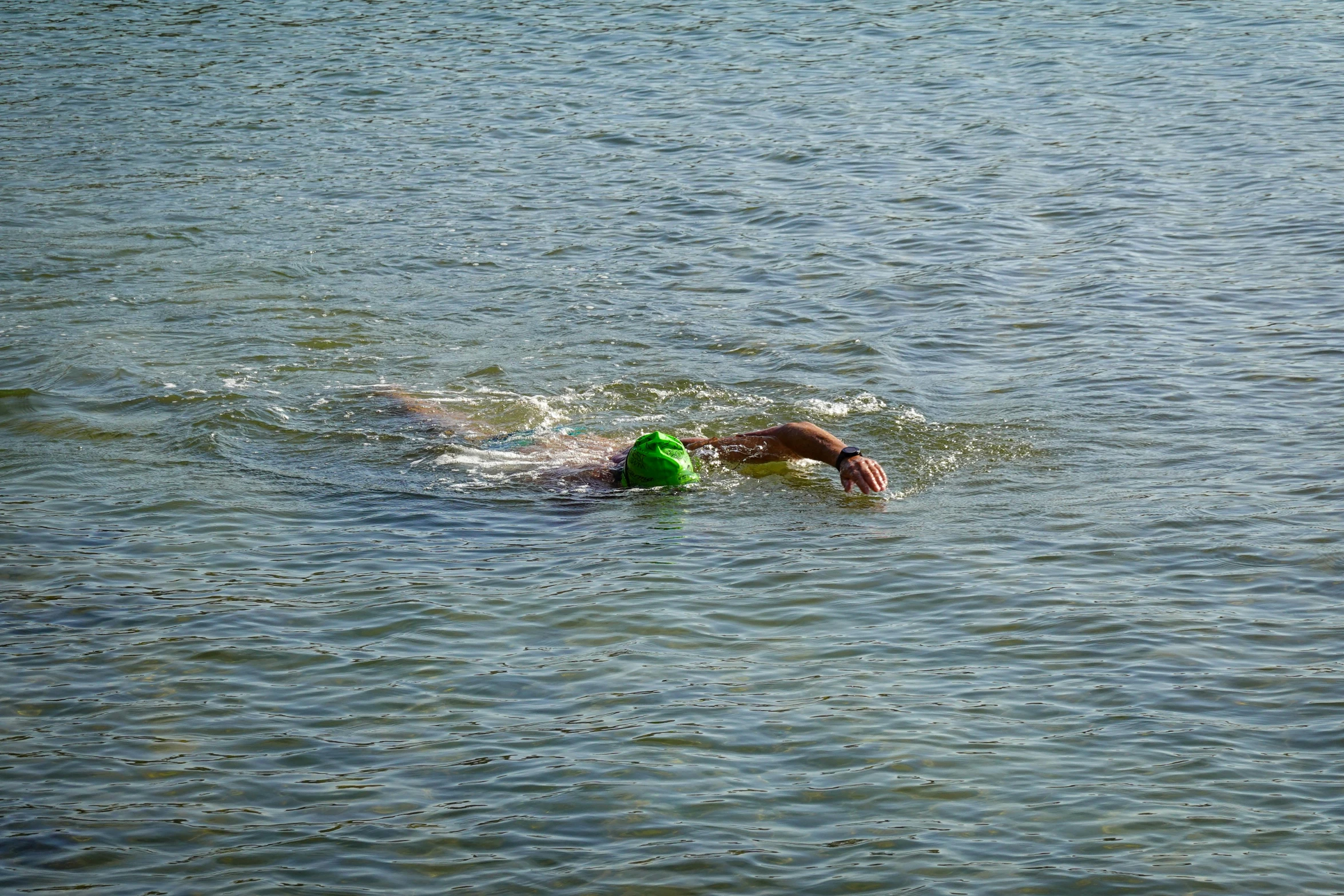 a person swimming in the water on a surfboard