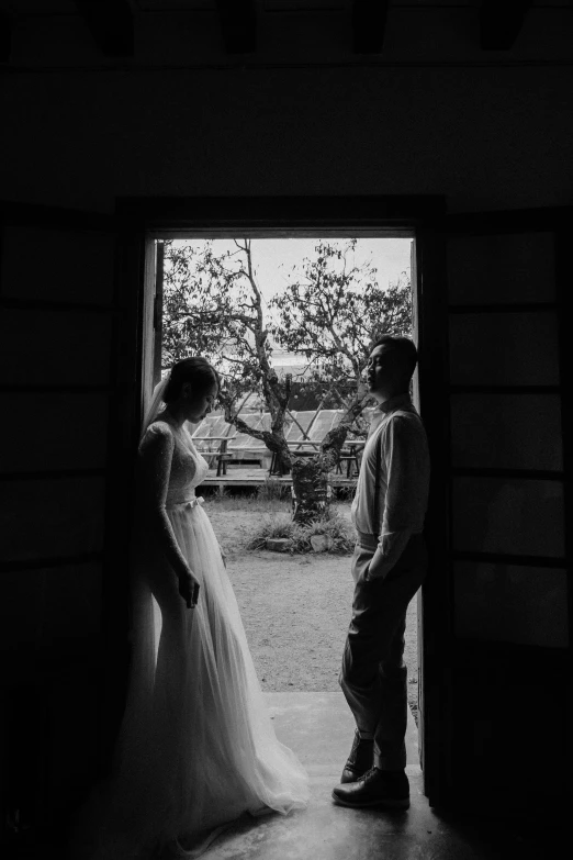 a man and woman standing next to each other near an open door