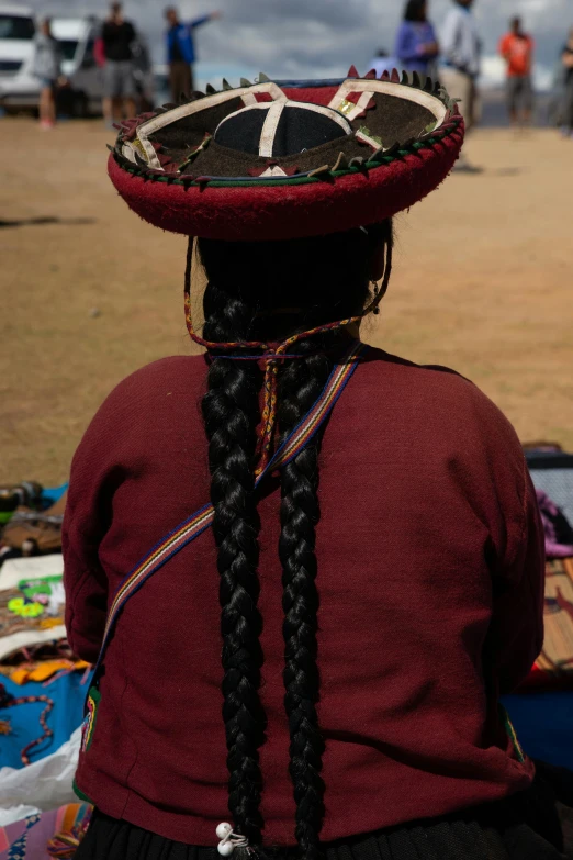 there is a woman with large hat in the air