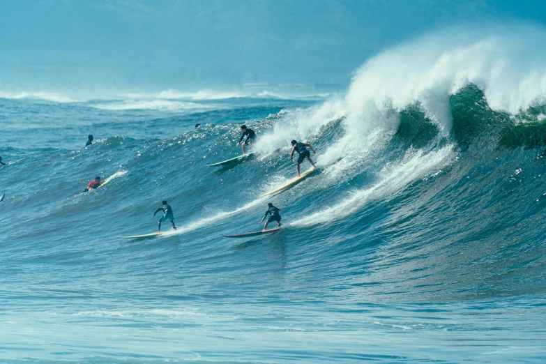 many people are riding waves on surfboards in the ocean