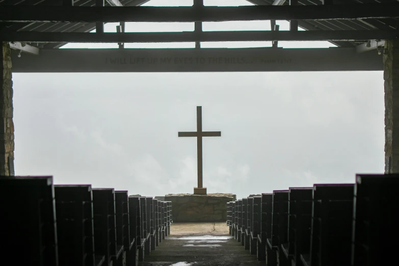 a large wooden cross on the side of a church