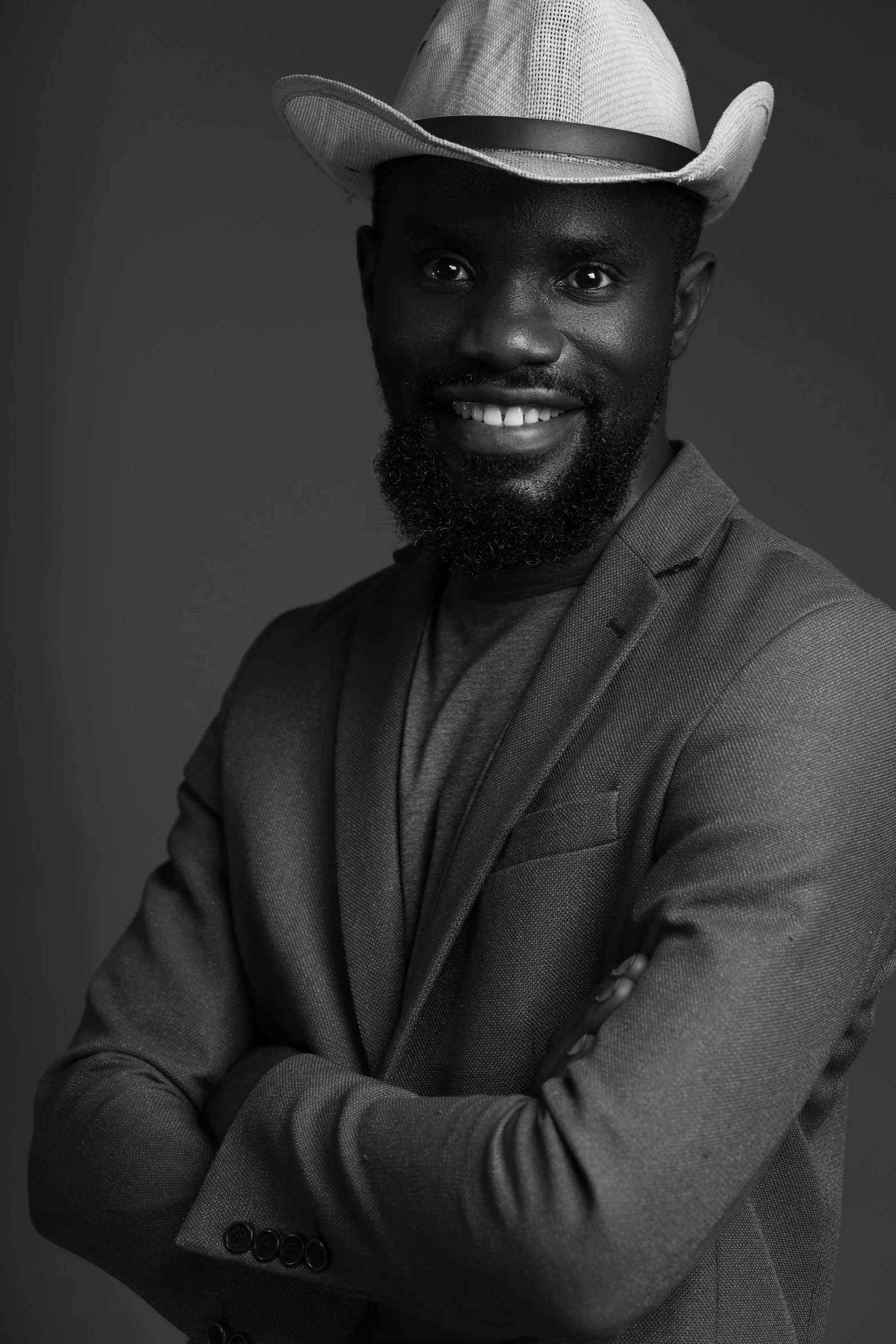 a man wearing a hat is posing for the camera