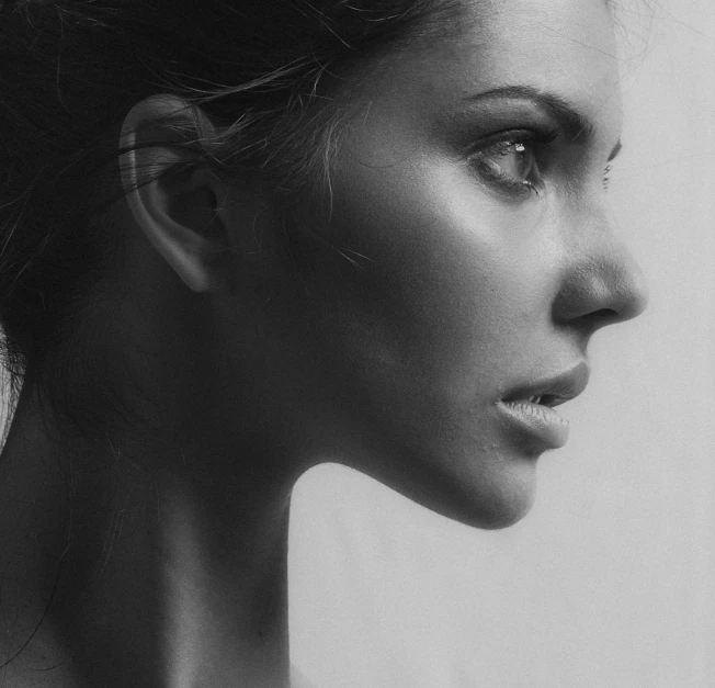 an up close picture of a woman's face with a hairdo