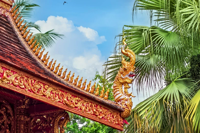 the roof of an ornate building, with palm trees in the foreground