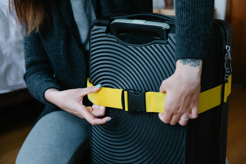 a woman is pulling her luggage from the seat