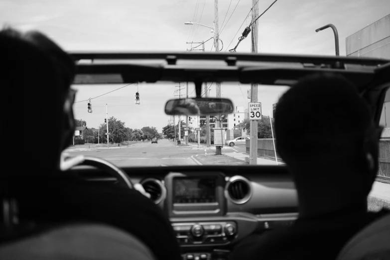 a man driving on a street next to an intersection