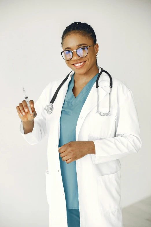 a woman wearing a lab coat and holding up a tooth brush