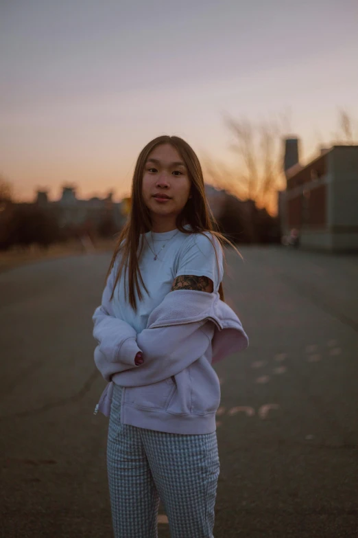 the young woman poses for a pograph near the street