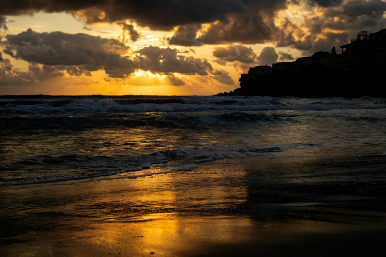 sunset reflects off the clouds over the ocean