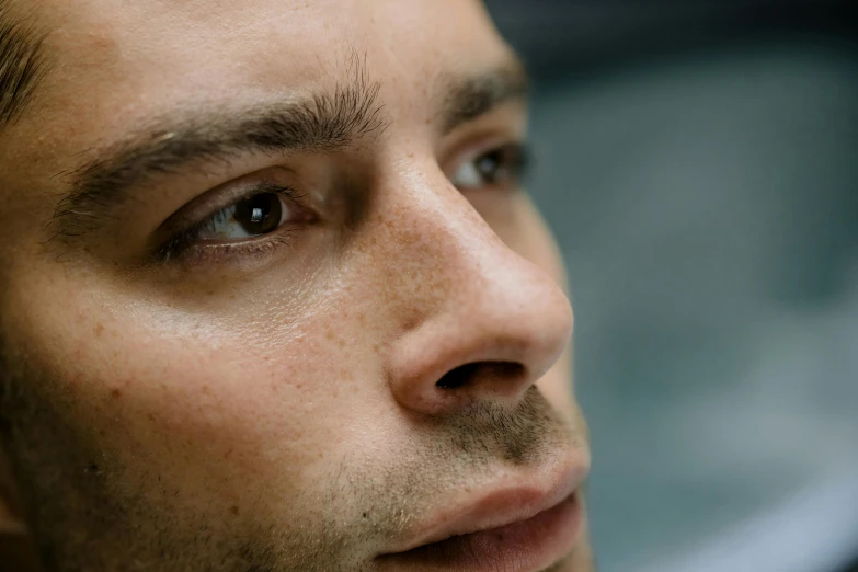 a young man looking ahead while wearing a tie