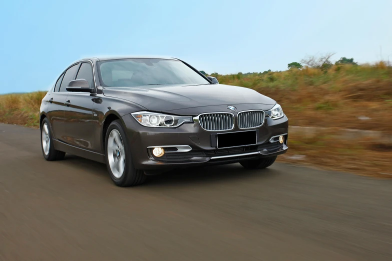 a silver bmw vehicle driving down the highway