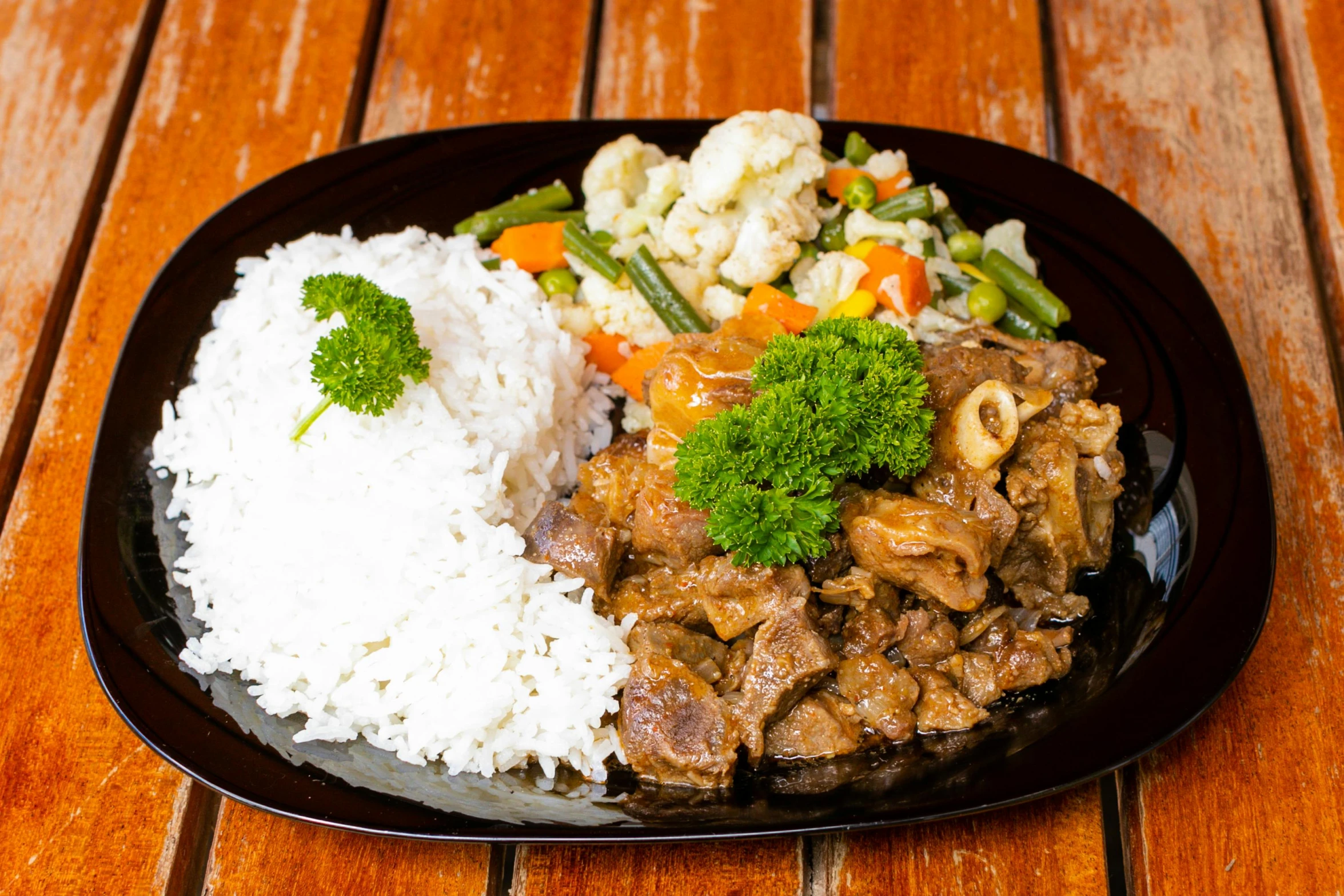 an asian dish is served with some white rice