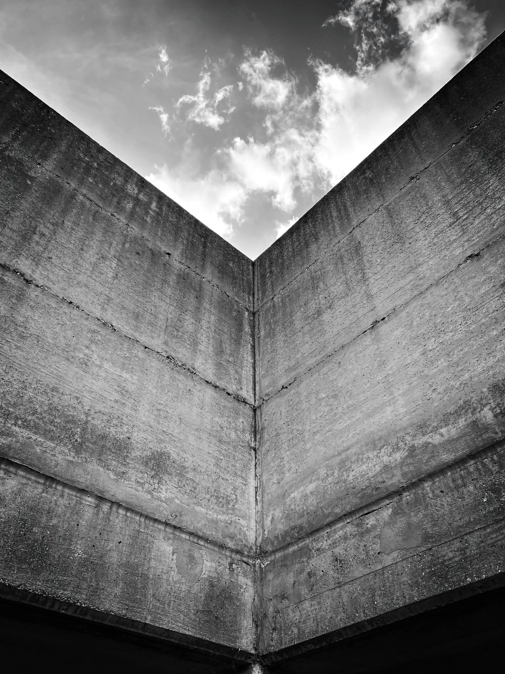 a clock on the wall of a concrete building