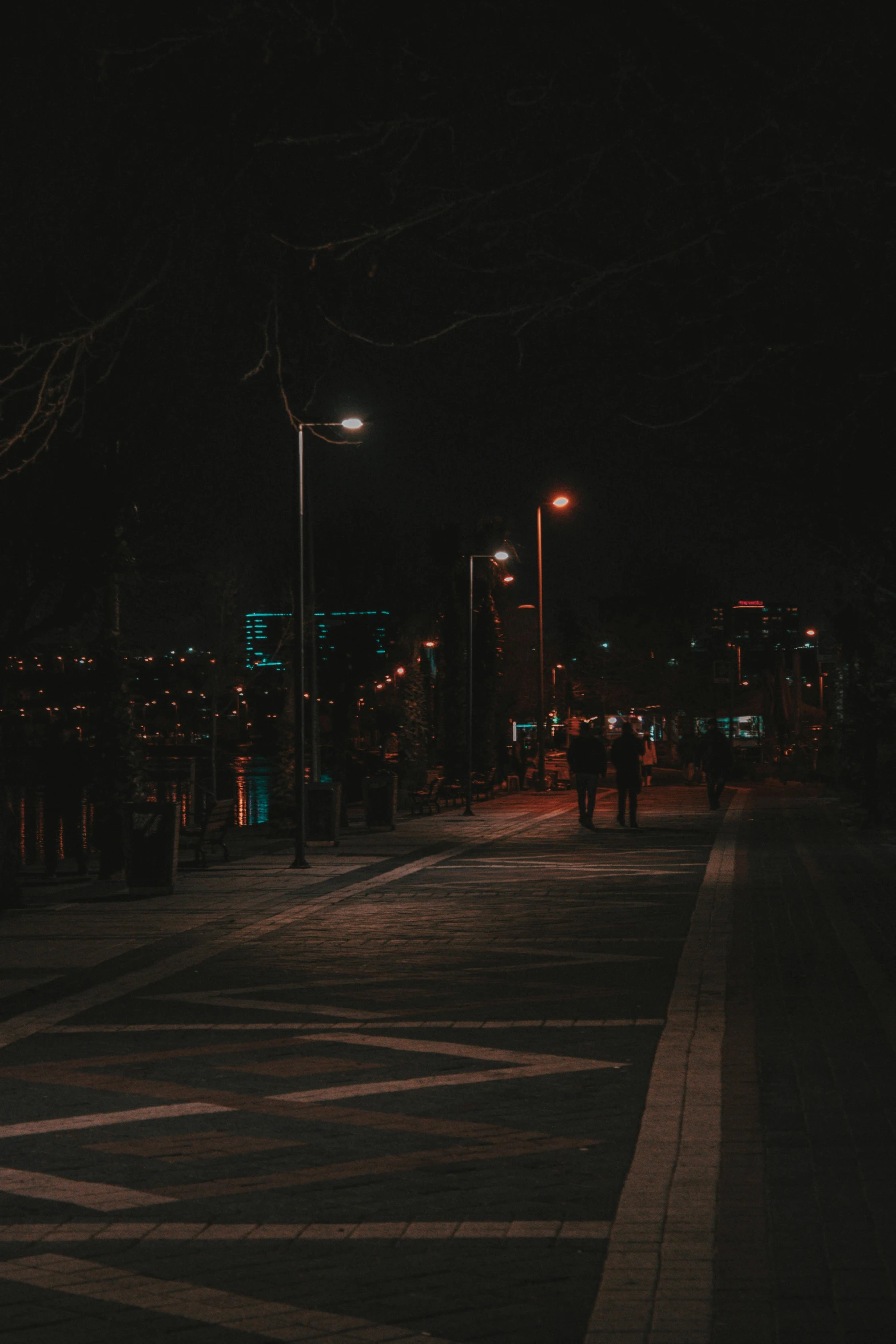 the light posts on the city street are lit up