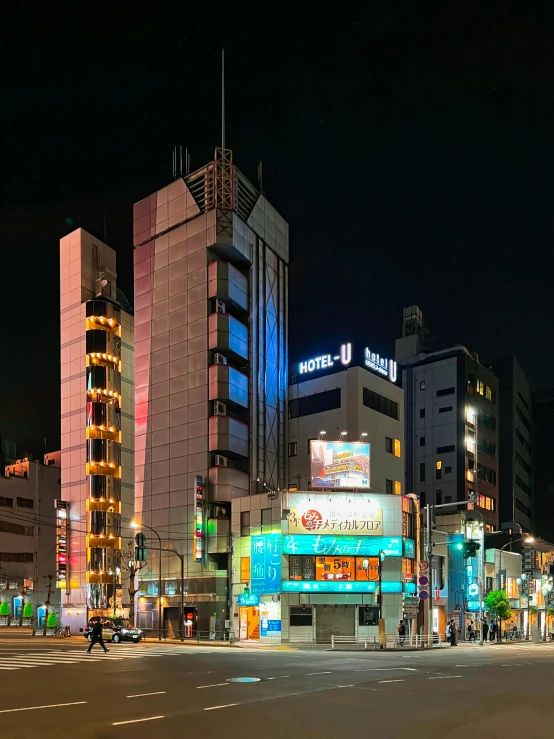 the city street is full of people and traffic at night