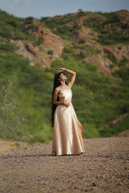 a young woman in a dress posing on the side of the road