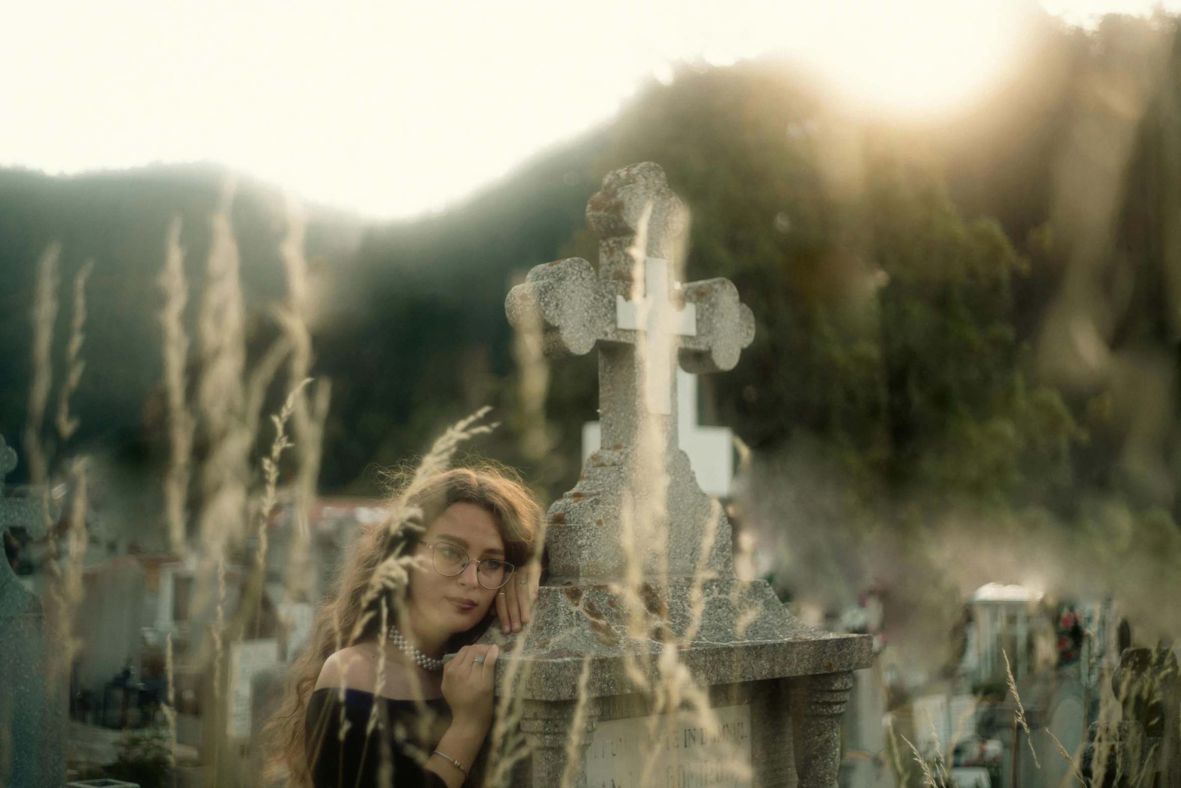 there is a woman in the middle of an old cemetery