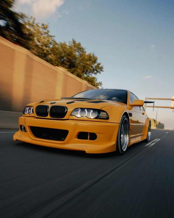 a yellow bmw parked on the street