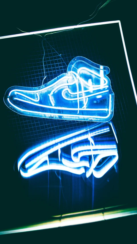 a blue neon shoe is seen with an image of a pair of shoes