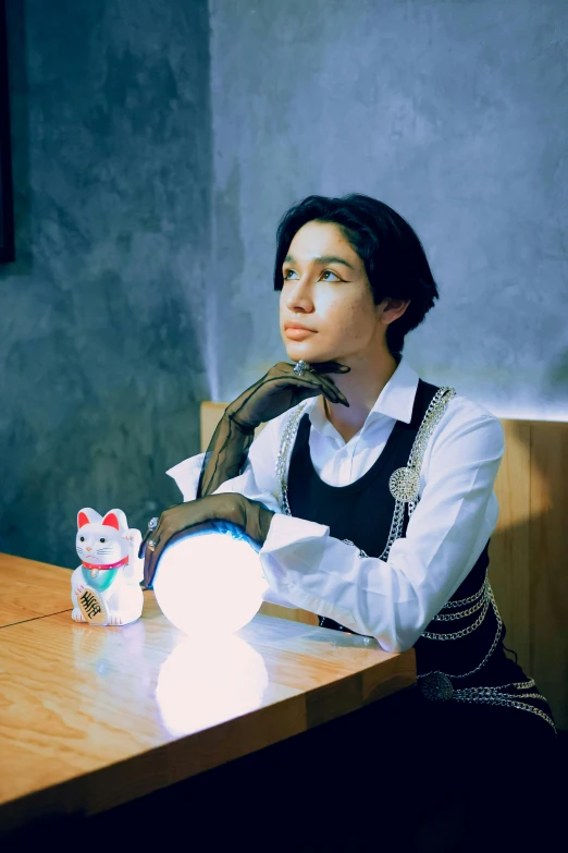 a woman sitting at a table and talking on a cell phone