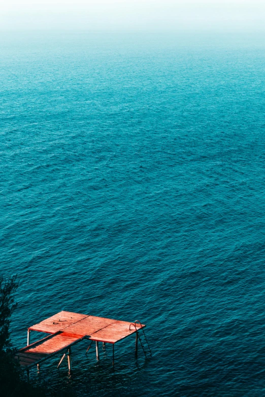 an over head po of the ocean and red pier