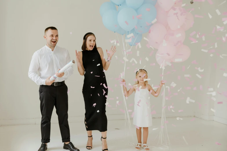 the two people are standing by a bunch of balloons