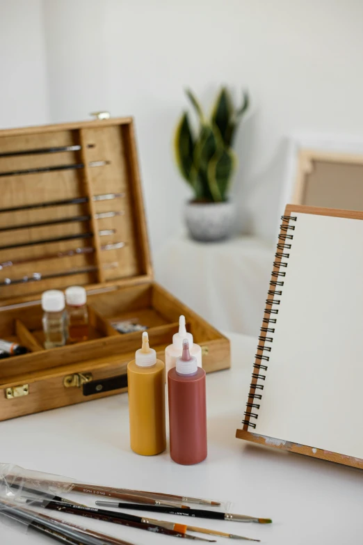 an artist's palette with empty bottles and paints