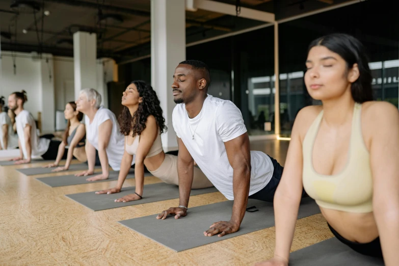 a group of people in yoga poses on a floor