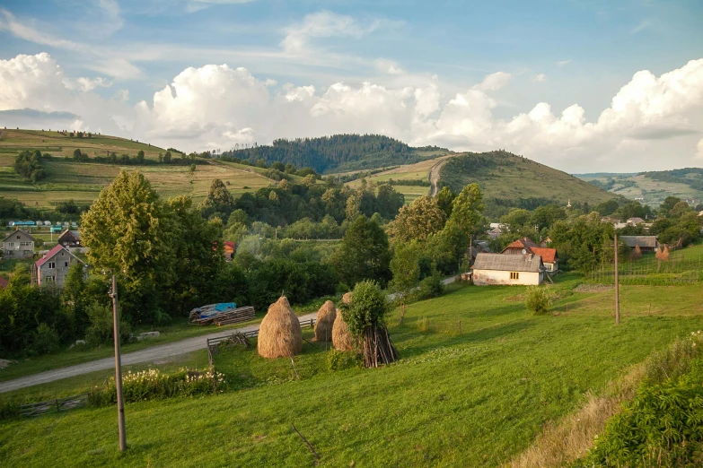 a field in the country with hay bails